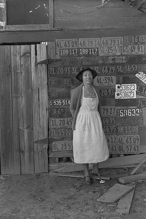 Farm woman beside her barn door by Dorothea Lange - Art Print