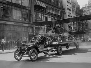 Biplane with spinning propeller is towed down Fifth Avenue New York for July 4th Parade - Art Print