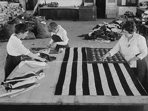 Flags laid out on cutting table to be sewn by Seamstresses who will make American ensigns during the period of the Great War - Art Print