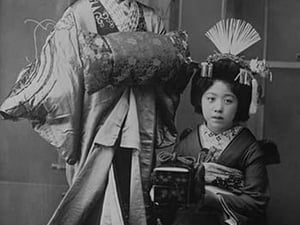 Two Young Beautiful Japanese Geishas accoutered in the ceremonial costumes and hairstyles of ancient Japan with Kimono
