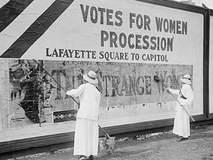 Suffragettes uses Long Brushes to Post a Billboard announcing a 'Votes' For Women' Parade - Art Print