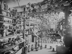 Owner sits in Retail Pottery Store waiting for Customers - Art Print