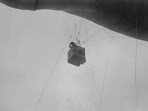 Military Observer hangs from a Balloon by guide wires looking over battlefield - Art Print