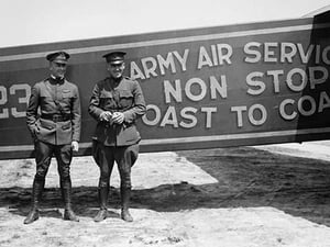 Pilots pose in front of a Plane that they fly coast to coast - Art Print
