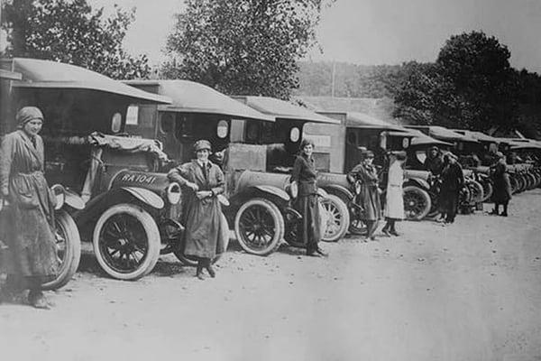 A line of Women Ambulance Drivers with their vehicles - Art Print