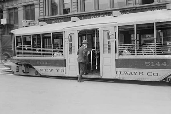 New Yorker appreciates the new Trolleys which are so low to the street that it takes but one step to access. - Art Print