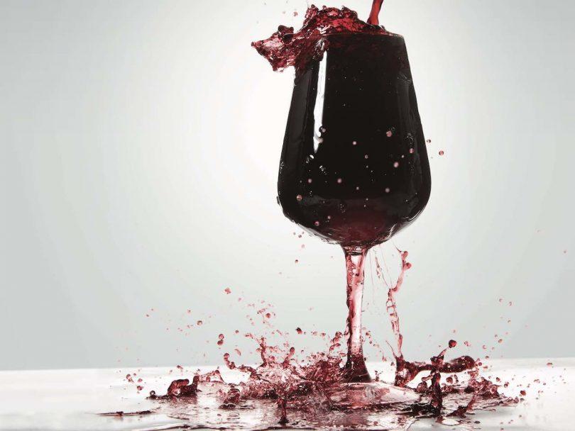 overfull glass of wine