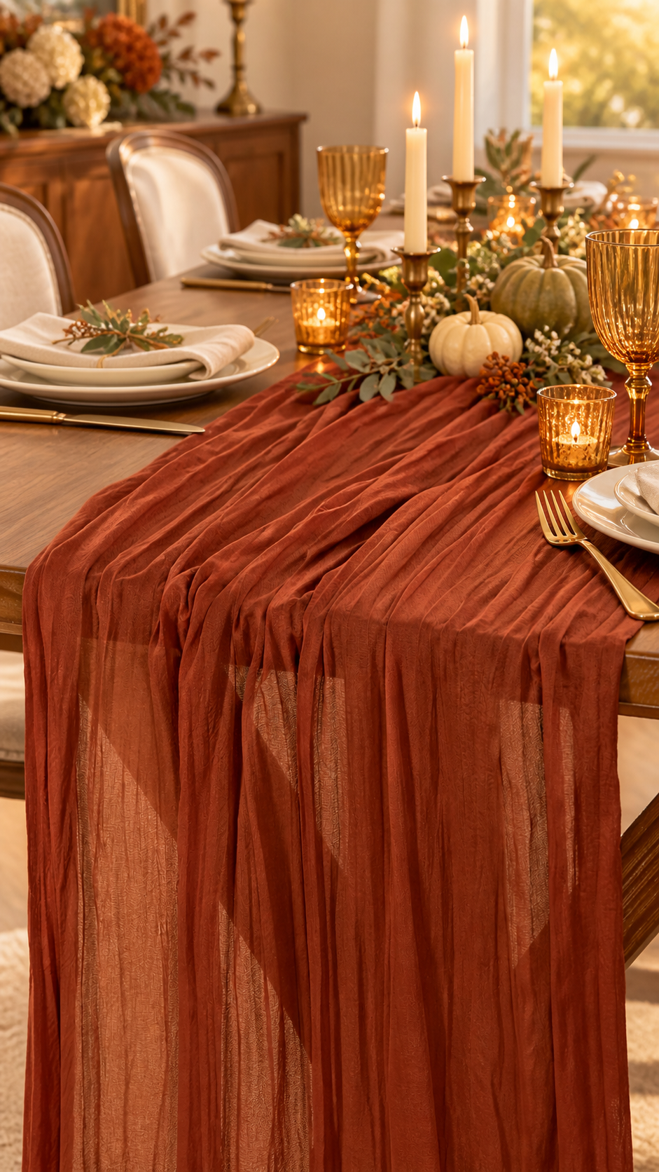 Terracotta cheesecloth runner styled on an elegant Thanksgiving dining table