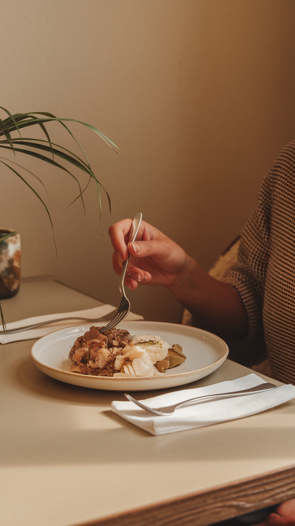 A person enjoying a plate of food, practicing mindful eating habits.