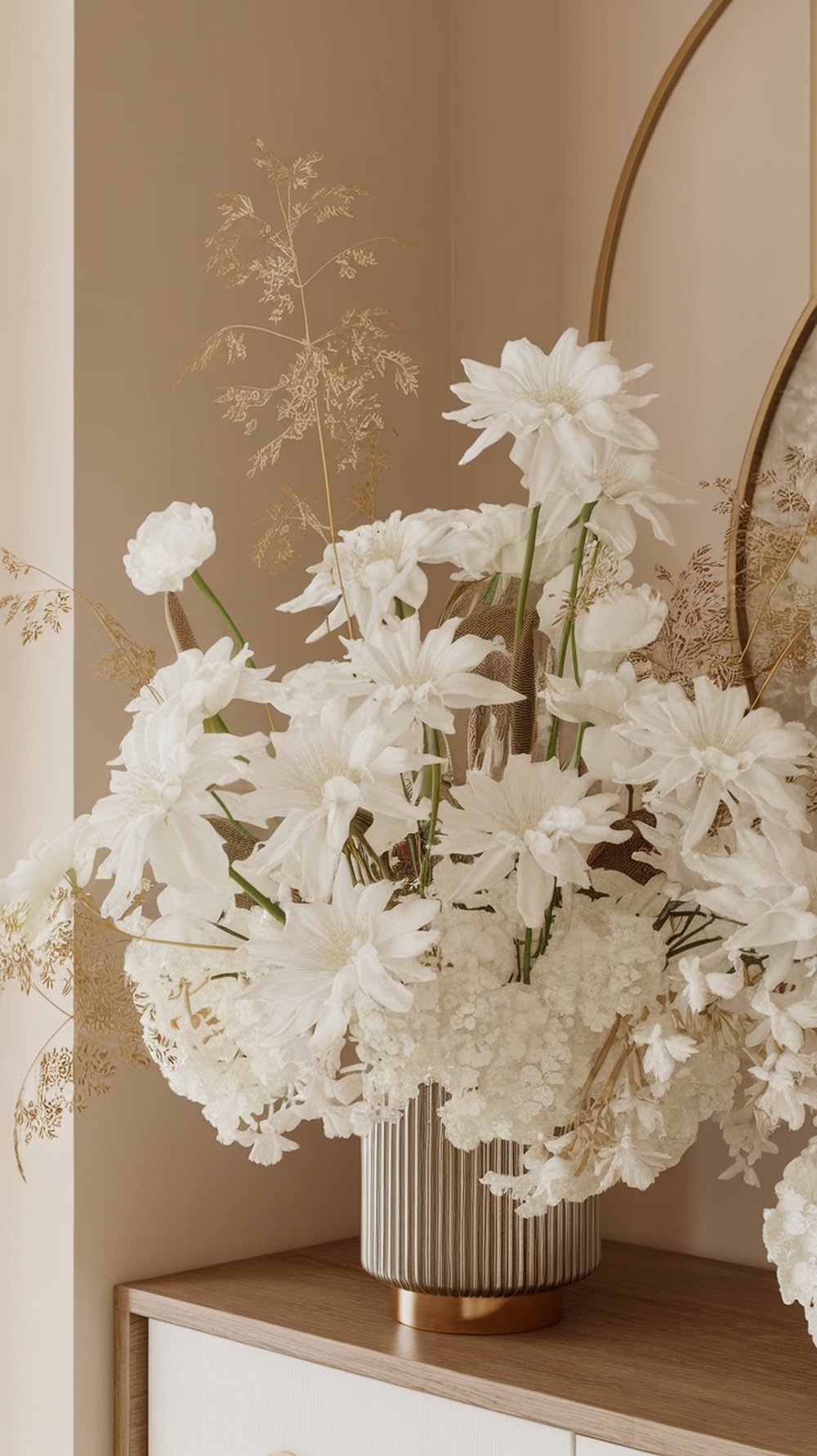 A beautiful arrangement of white flowers in a gold-accented vase, set against a soft neutral background.