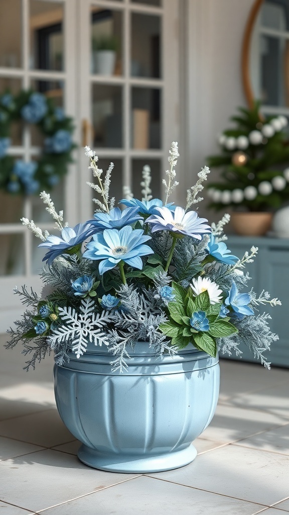 A frosty blue and white floral arrangement in a light blue planter, featuring blue flowers, white accents, and frosted greenery.