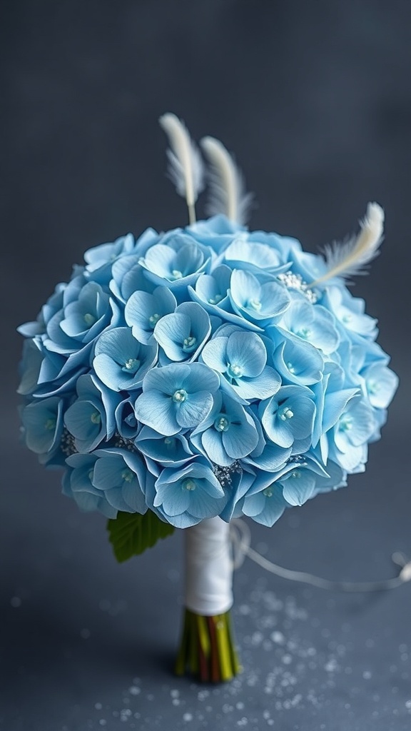 A winter wedding bouquet featuring icy blue hydrangeas with silver dust and delicate feathers.