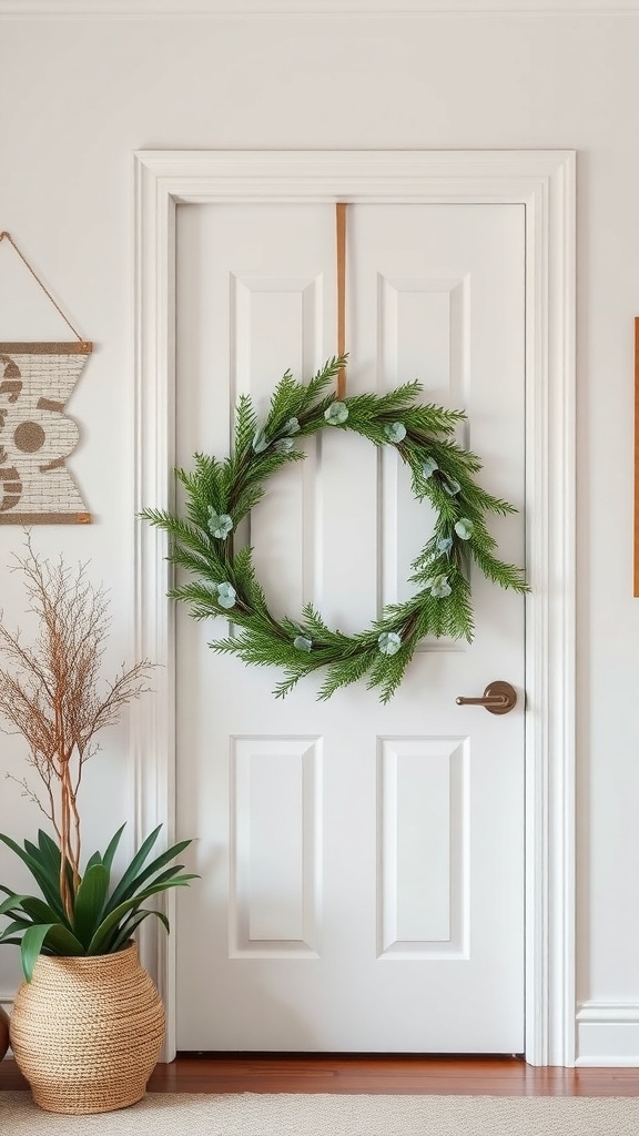 A natural pine and eucalyptus wreath hanging on a white door, with a simple design and a cozy feel.