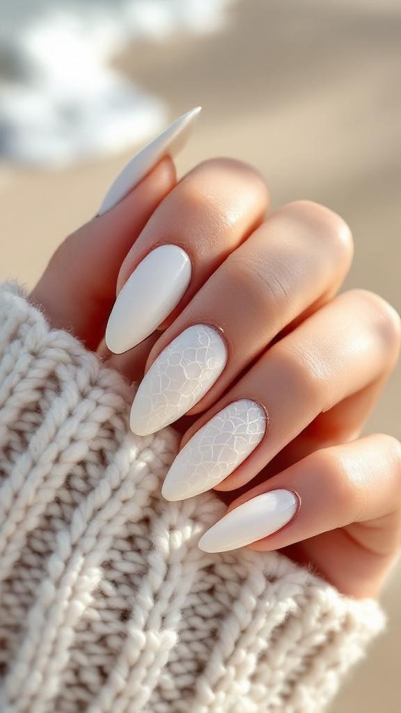 A close-up of textured white nails with a glossy finish and a cozy knit sweater.