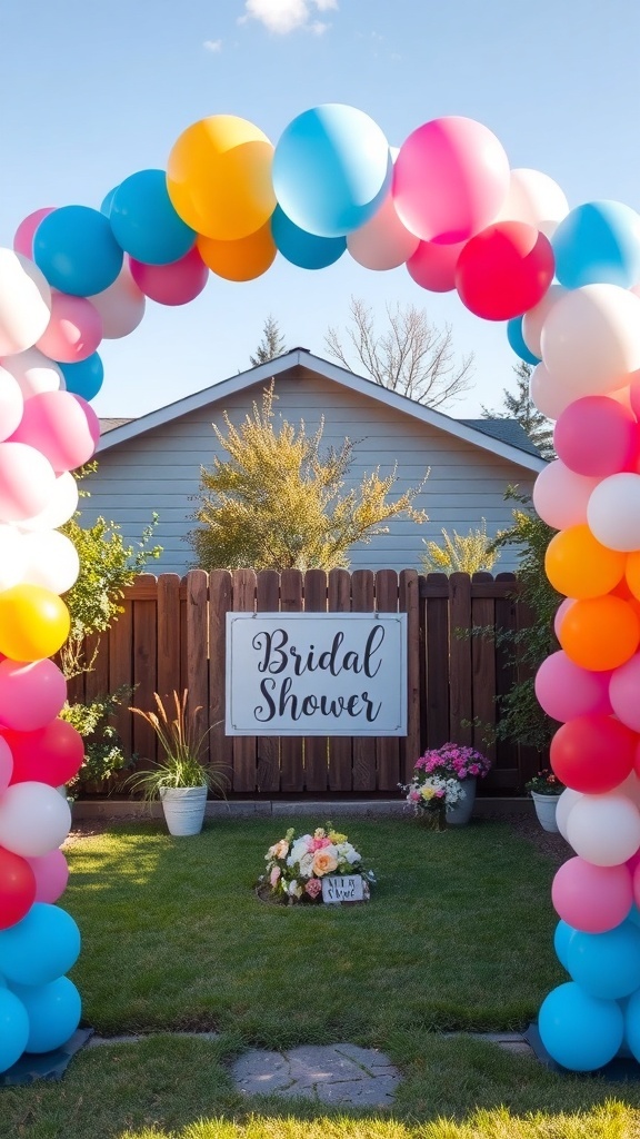 A colorful balloon arch with a 'Bridal Shower' sign in a backyard setting.