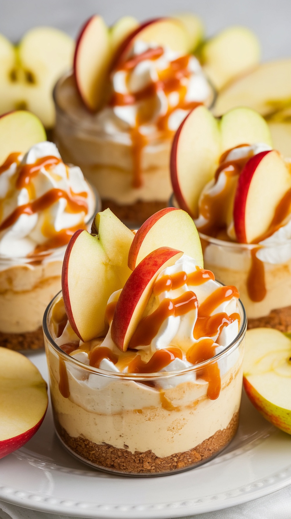 No-bake apple cheesecake cups topped with caramel and apple slices