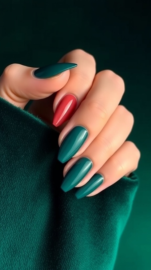 A hand with long, pointed nails painted in various shades of green, featuring a gem accent on one nail.
