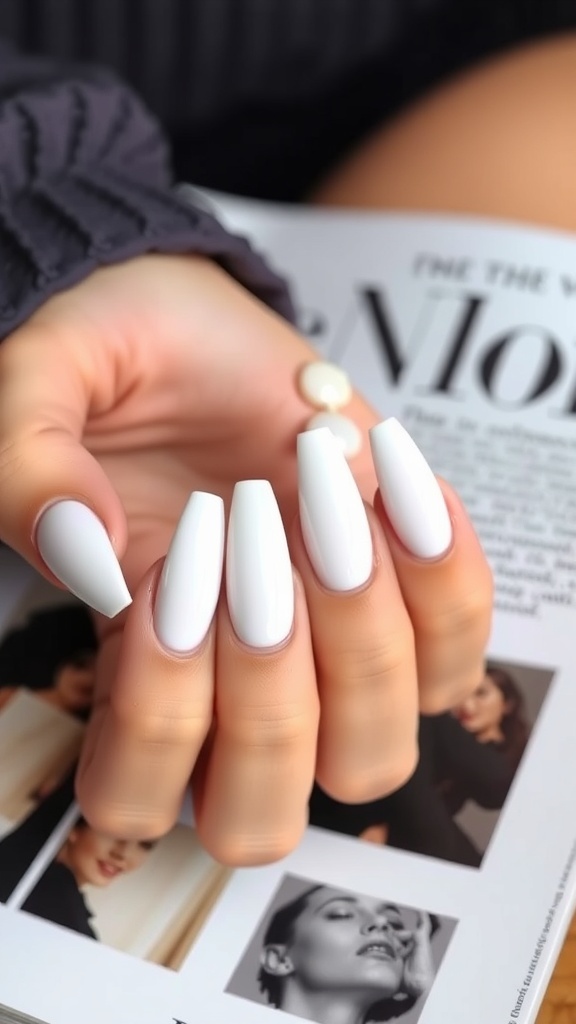 A hand with long almond-shaped French nails resting on an open book, surrounded by decorative elements.