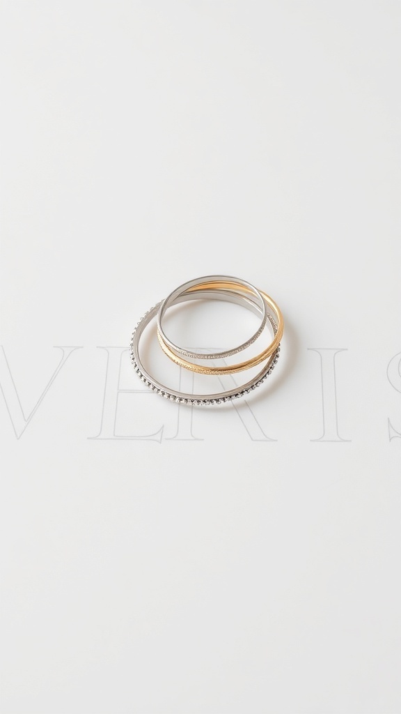A collection of minimalist rings stacked together on a light background.