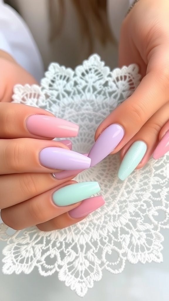 A hand with beautifully painted pastel nails in lavender and mint green, set against a lace background.