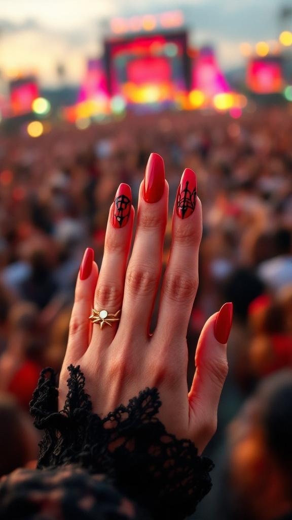 A hand with edgy red nails and rings at a concert, with festival lights in the background.