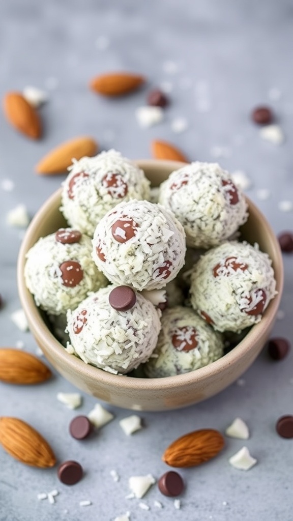A bowl of Almond Joy Energy Bites with almonds and chocolate chips scattered around.