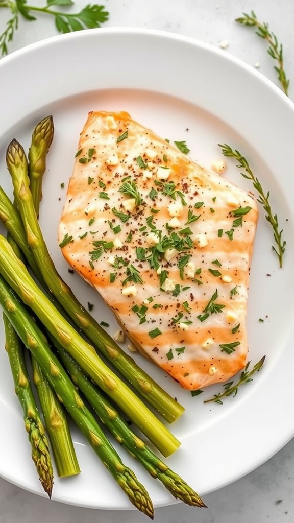 A plate of garlic herb salmon with asparagus, garnished with fresh herbs.