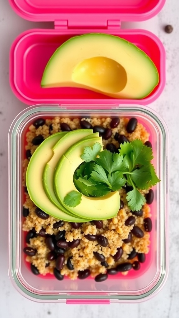 A colorful quinoa black bean bowl with avocado and cilantro in a pink lunchbox.