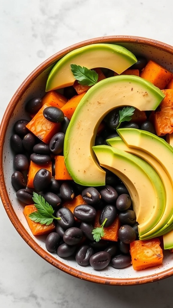 A colorful bowl featuring sweet potatoes, black beans, and avocado slices, garnished with cilantro.