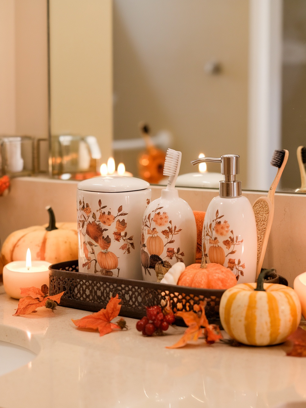 A cozy fall-themed bathroom decor featuring pumpkins, candles, and decorative bath accessories.