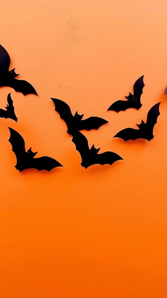 Black bat silhouettes on an orange background
