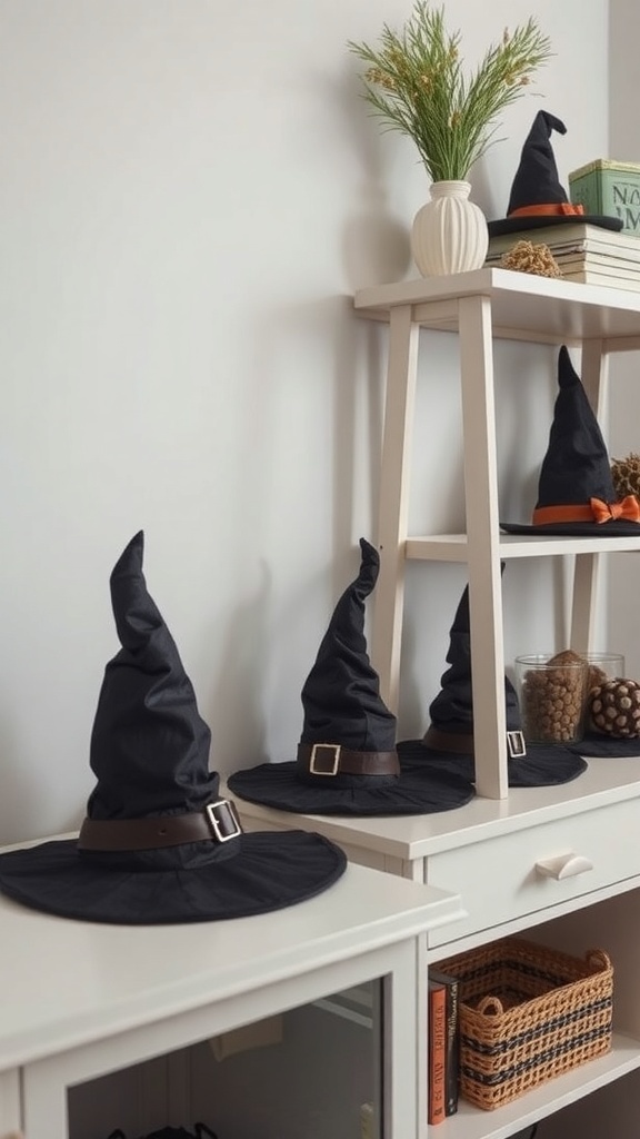 A shelf displaying several black witch hats with colorful bands, alongside a small plant and books.