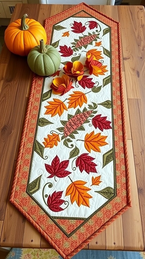 A handmade quilted table runner with autumn leaves and flowers, placed on a wooden table with pumpkins.