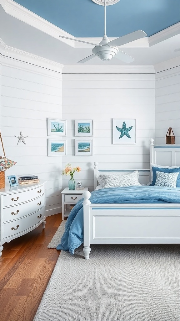 A serene coastal-themed bedroom with blue accents, featuring a light blue ceiling, white shiplap walls, and simple white furniture.