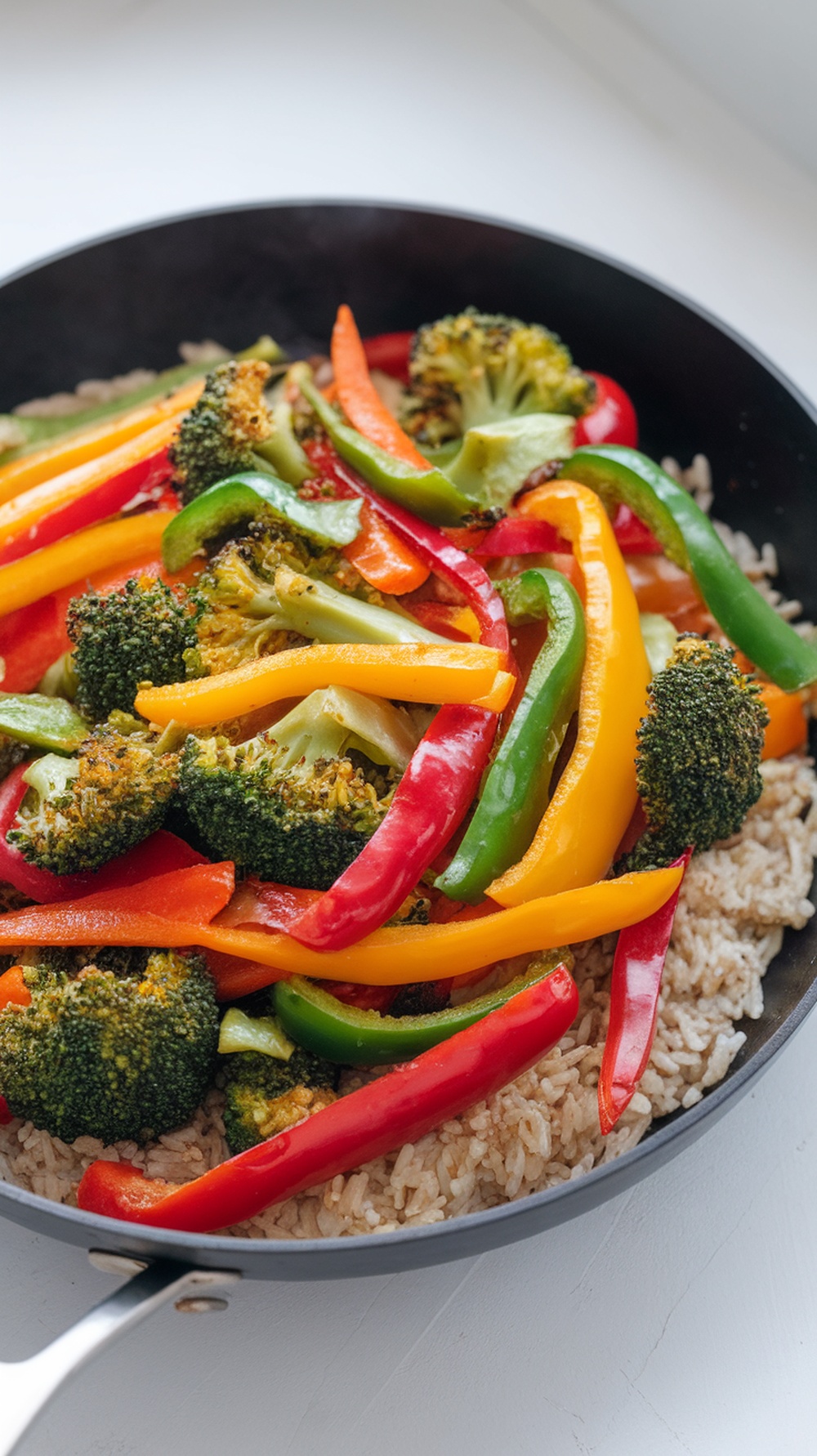 A colorful vegetable stir-fry with broccoli and bell peppers in a skillet.