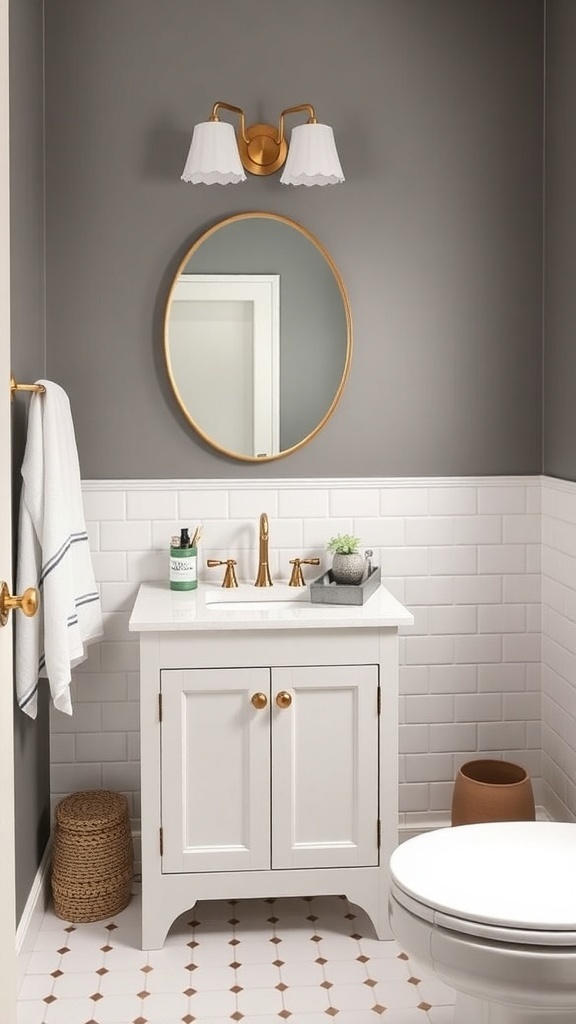 A small bathroom featuring a compact white vanity with gold accents, a round mirror, and gray walls.