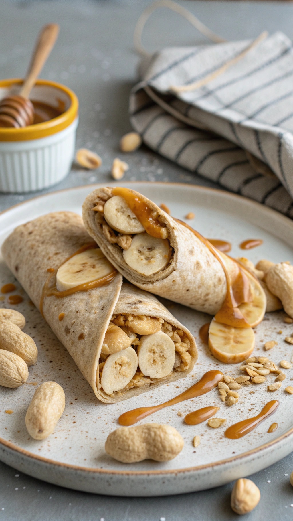 Peanut butter banana wrap on a plate with honey and peanuts