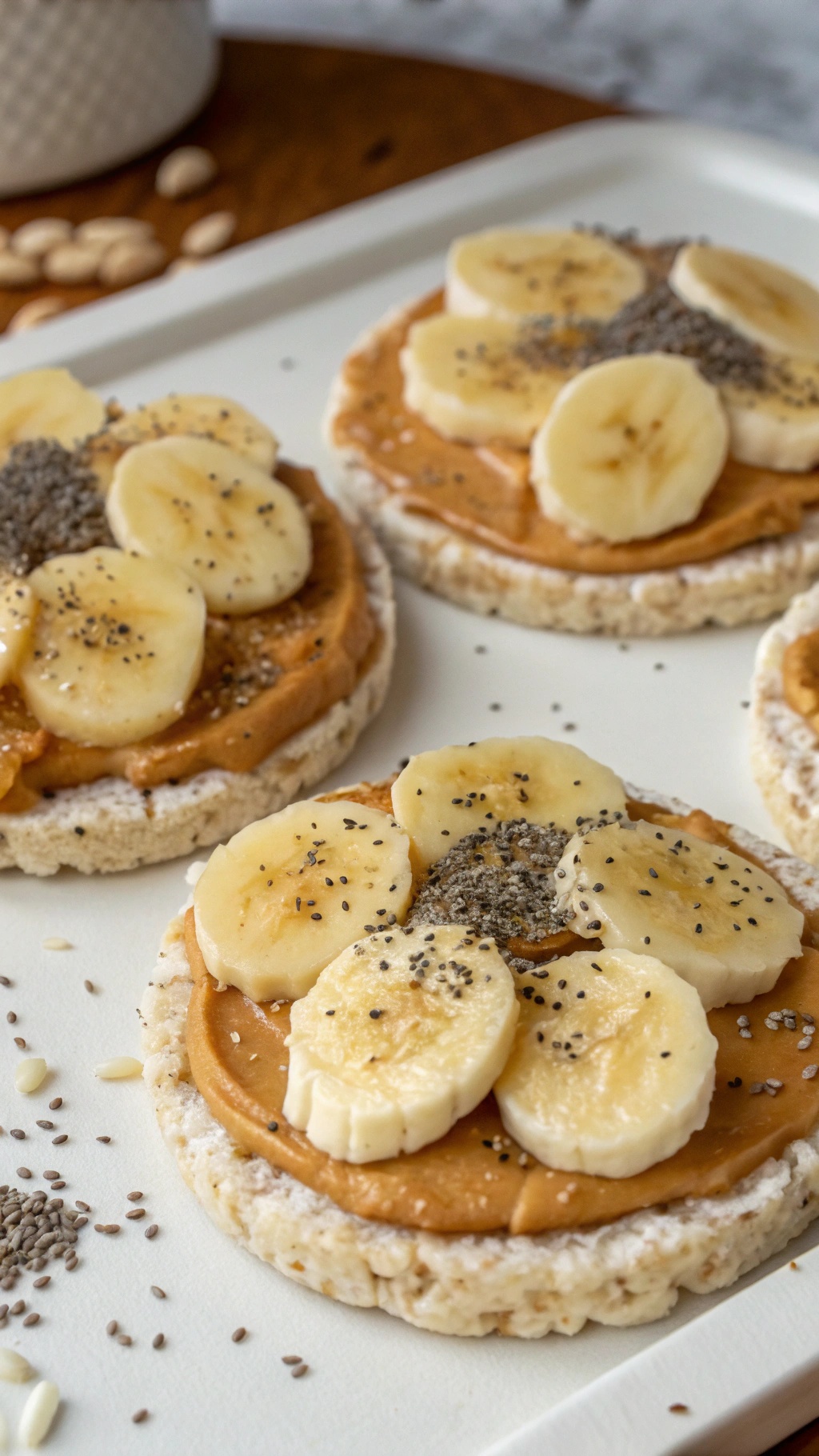 Rice cakes topped with nut butter, banana slices, and chia seeds