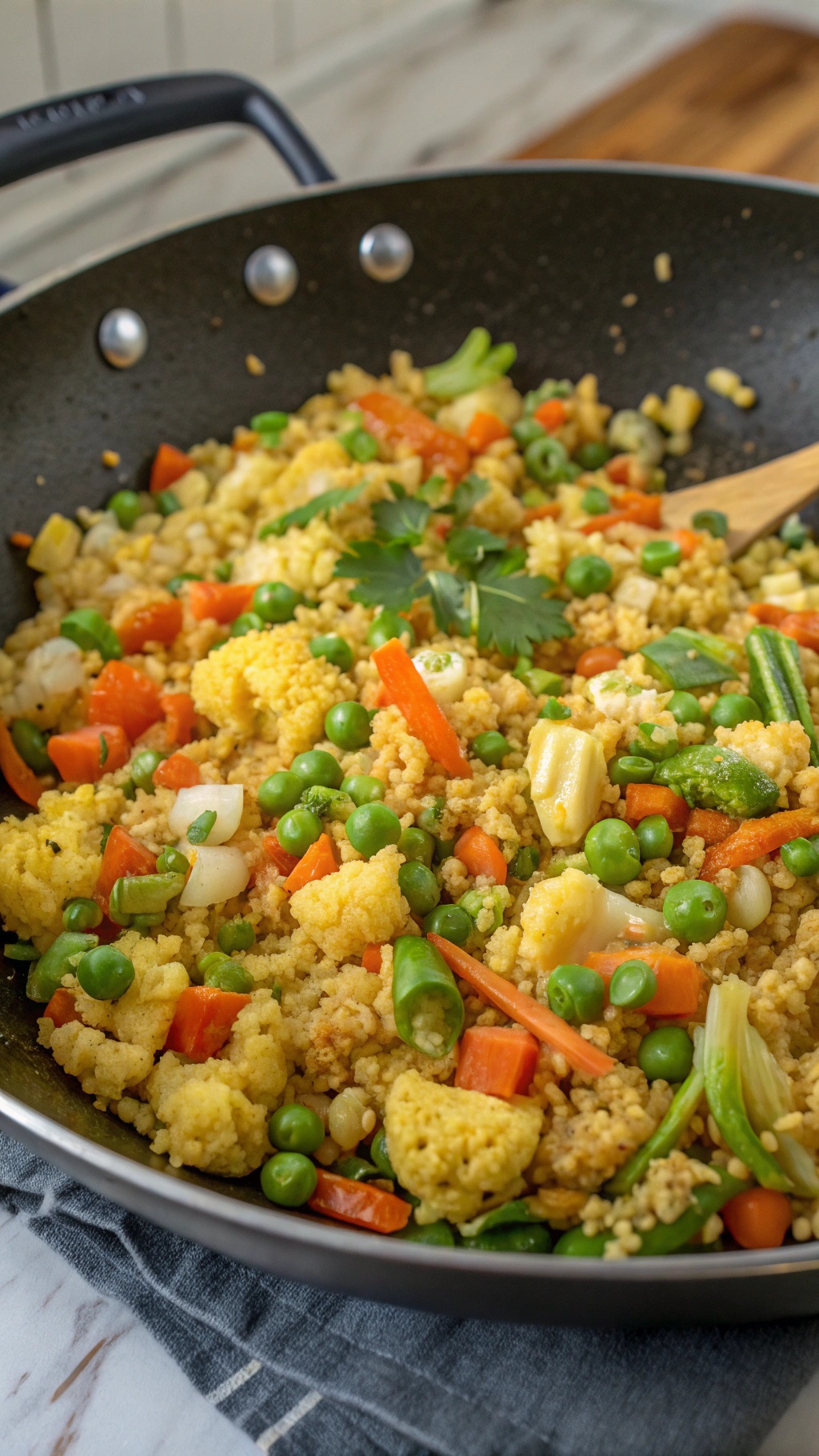 A colorful bowl of cauliflower fried rice with mixed vegetables and green onions