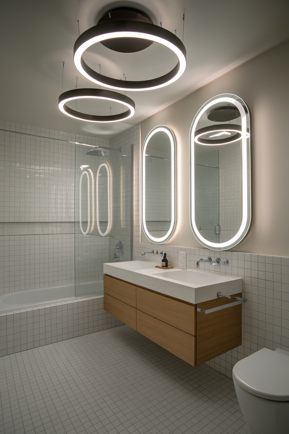 A modern bathroom featuring circular statement lighting fixtures, sleek mirrors, and wooden cabinetry.