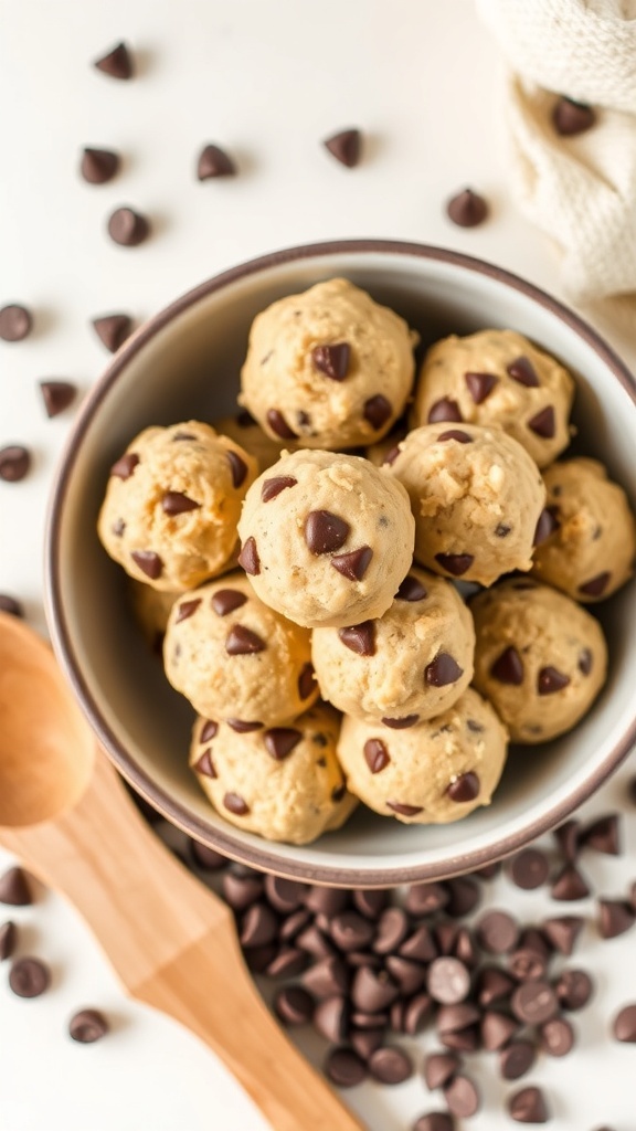 A bowl filled with no-bake chocolate chip cookie dough bites surrounded by chocolate chips.