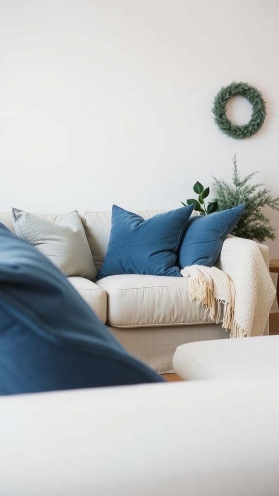Cozy couch with blue throw pillows and a blanket, decorated for Christmas.