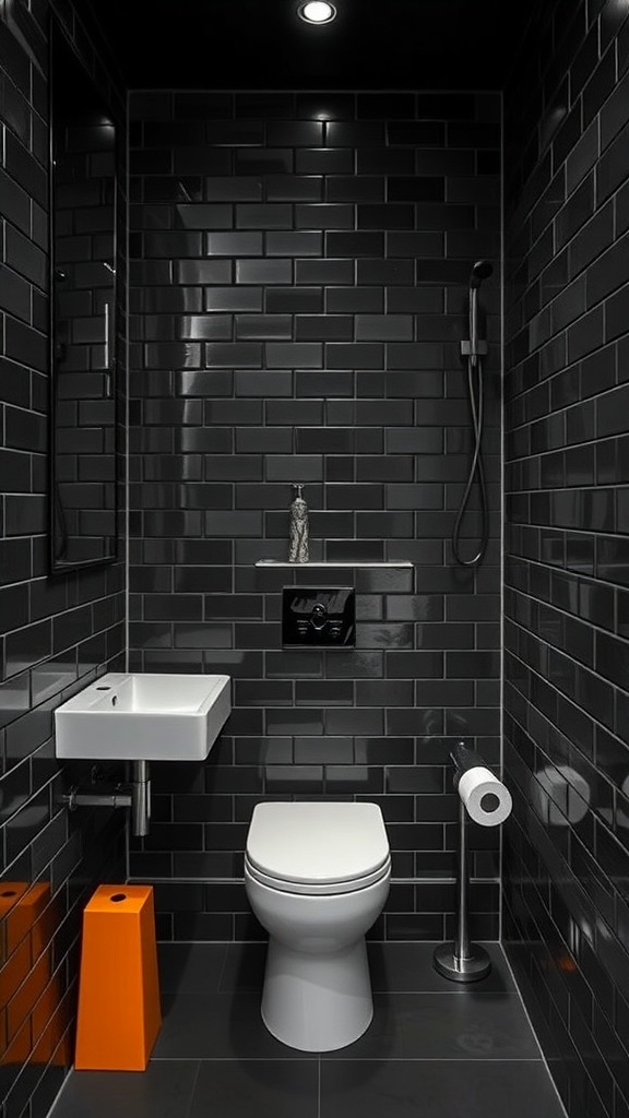Compact bathroom with matte black subway tiles, minimalistic fixtures, and bright orange accents.