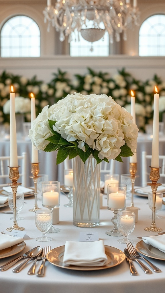 A table set with a tall vase of white hydrangeas, surrounded by candles and elegant tableware.