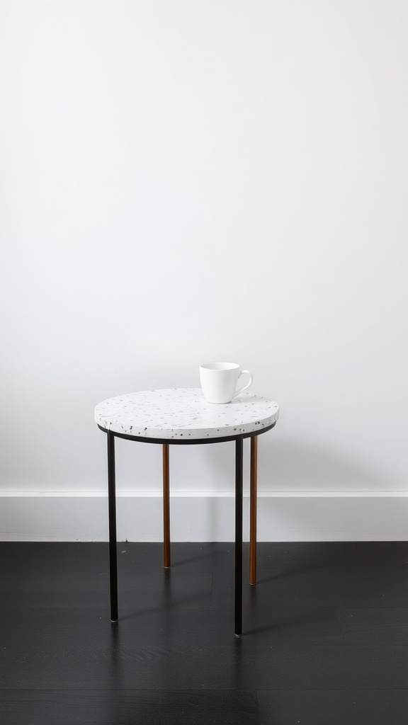 A stylish terrazzo side table with a white top and black speckles, featuring black and copper legs, set against a simple background.