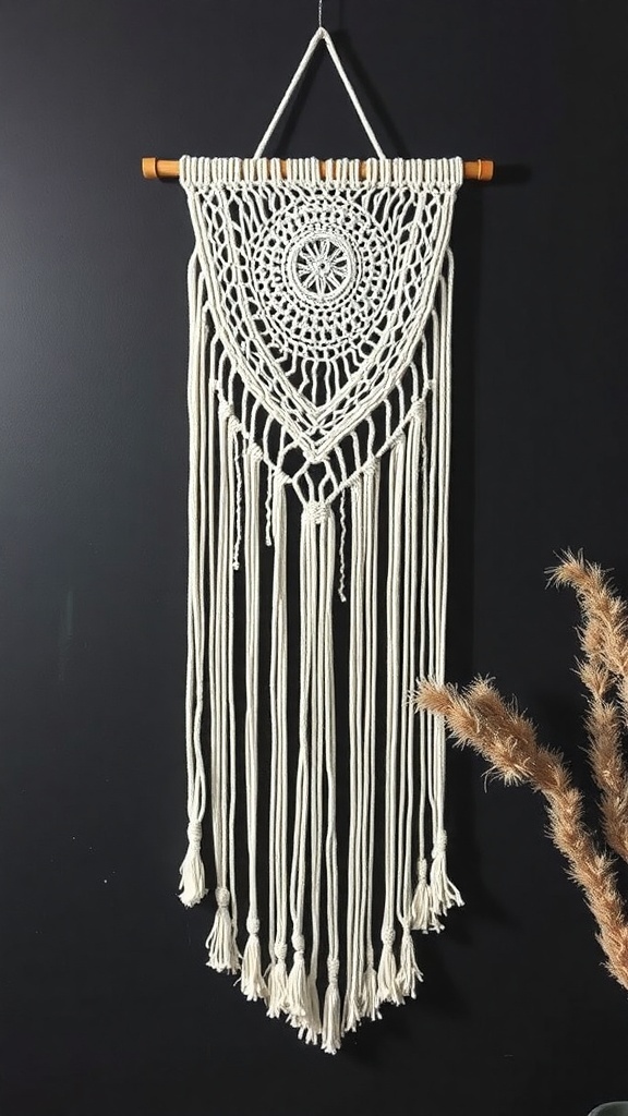 A macrame wall hanging resembling a ghost, made from white yarn with intricate knots and flowing strands.
