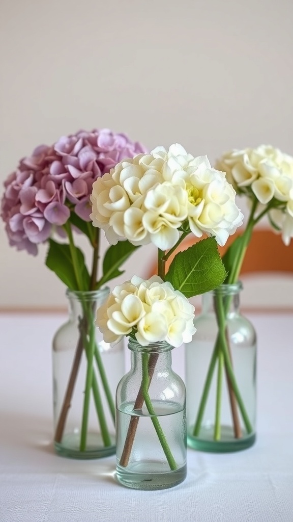Mini hydrangea bouquets in vintage bottles with purple and white flowers