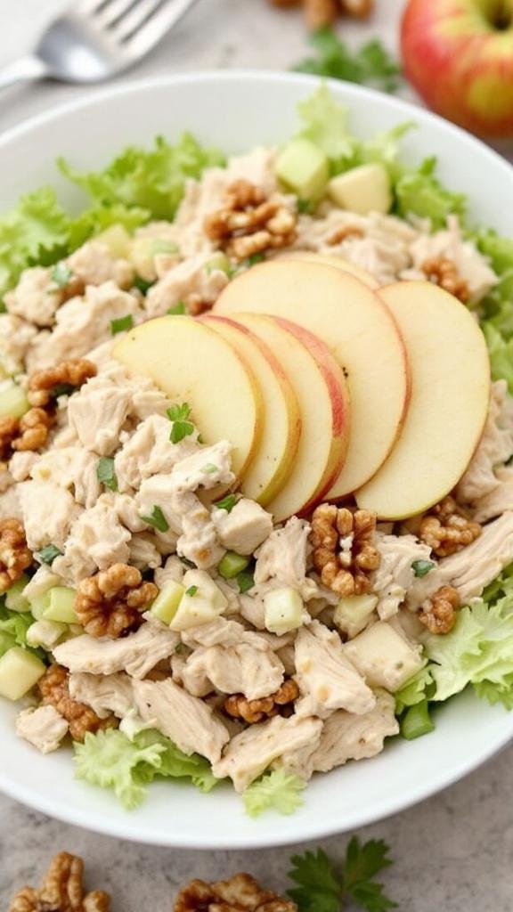 A bowl of Classic Waldorf Rotisserie Chicken Salad with apples, walnuts, and lettuce.