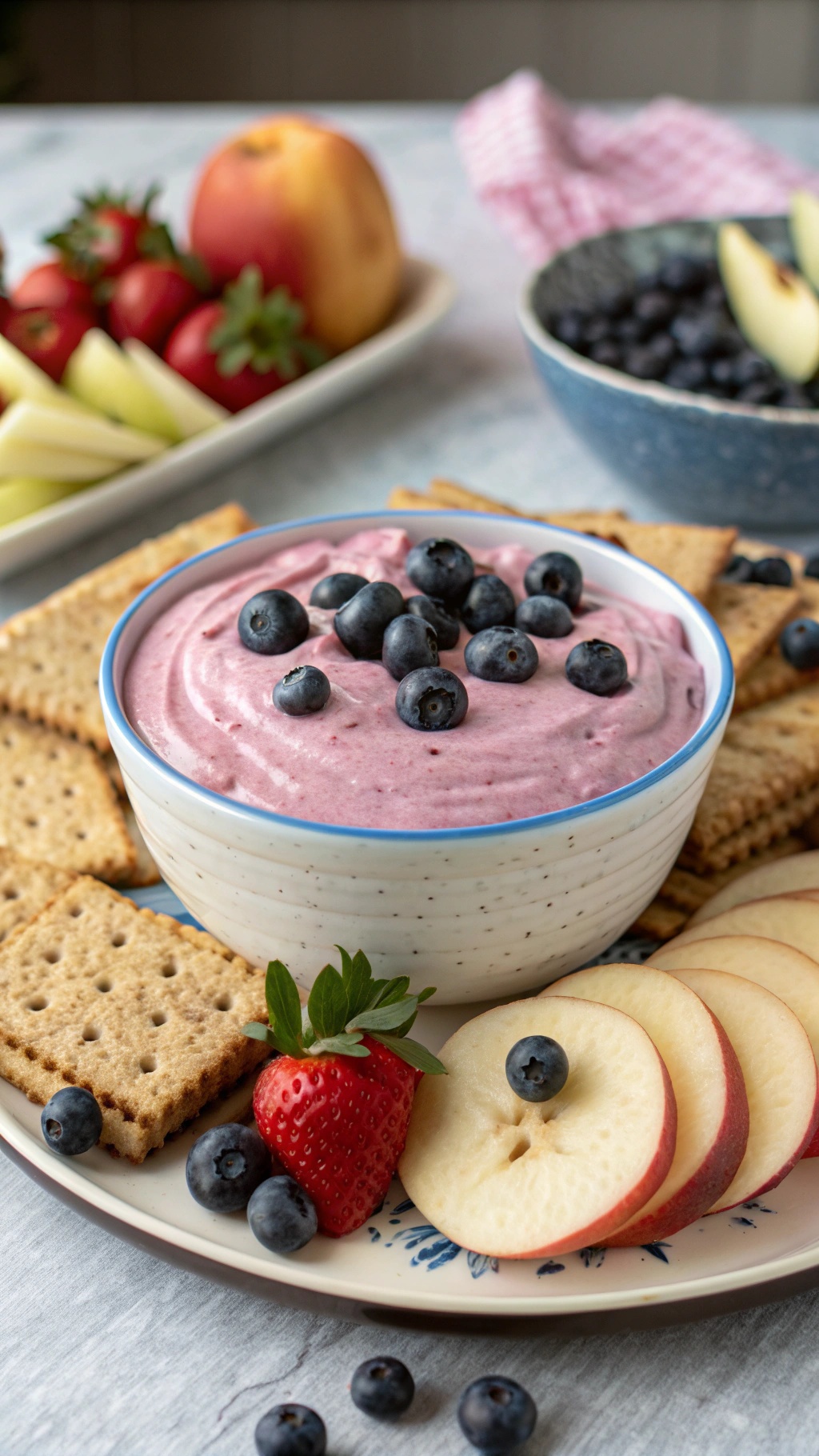A creamy blueberry Greek yogurt dip served with graham crackers and fresh fruit.