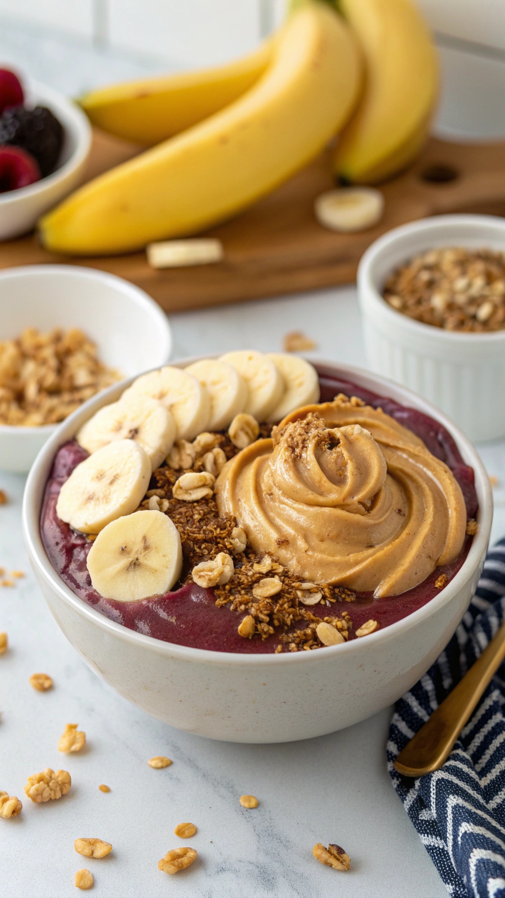 A delicious Peanut Butter and Banana Acai Bowl topped with banana slices, granola, and peanut butter.